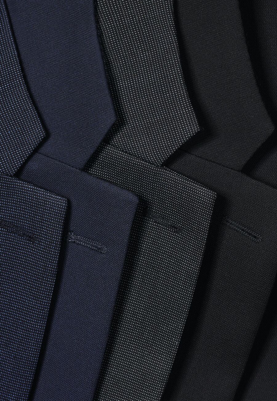 Row of suit lapels in navy, charcoal and pinstripe fabrics