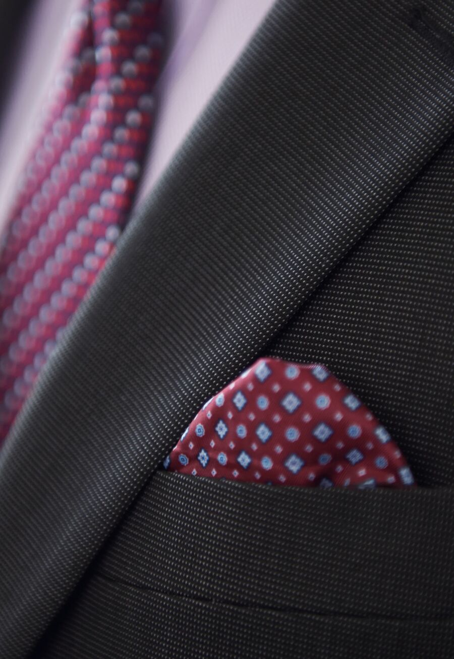 Close-up of a patterned pocket square finishing a tailored jacket